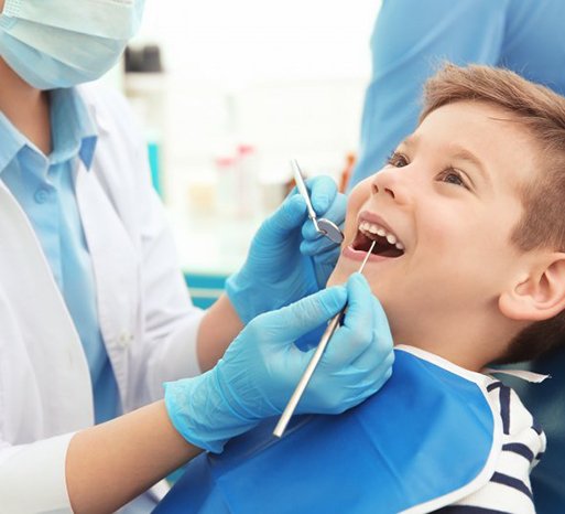 a child undergoing a dental checkup with his dentist
