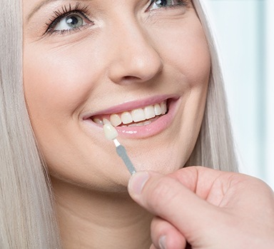 Woman having teeth color matched for cosmetic dentistry in Itasca, IL