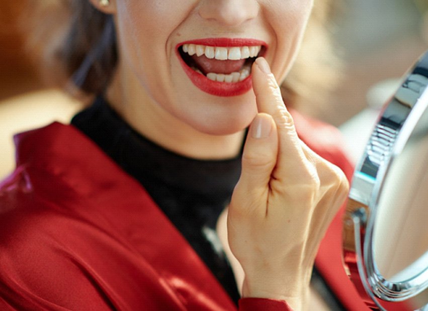 Woman pointing to her tooth