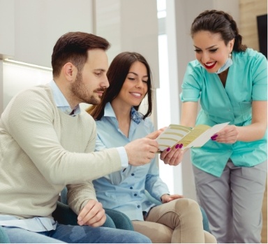 Dental team member explaining the cost of dental implants