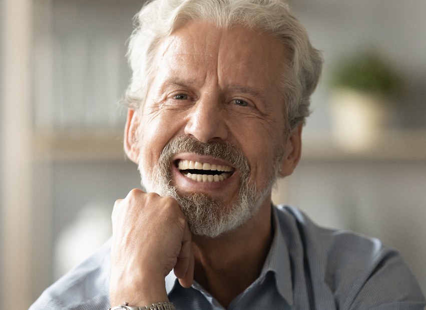 An older man smiling with dentures