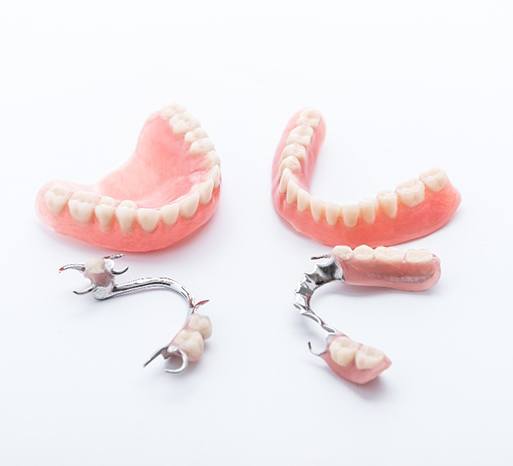 Sets of dentures against a gray background