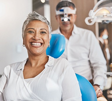 Woman smiling while sitting in dentist's treatment chair
