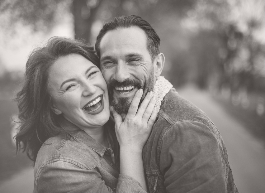 Man and woman with healthy smiles after emergency dentistry