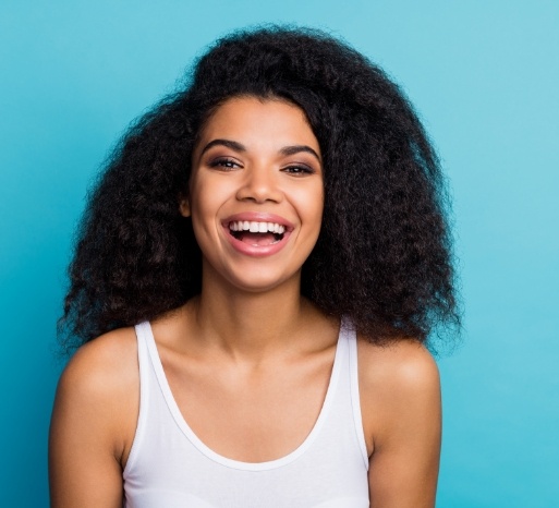 Woman sharing flawless smile after makeover