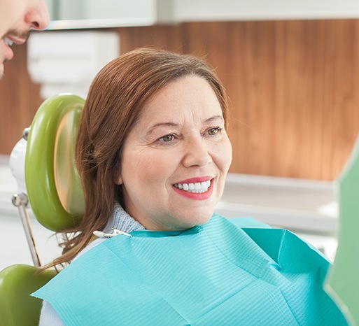 Woman smiling in the denture chair