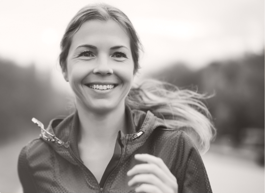 Woman with perfected smile after Invisalign clear aligner treatment