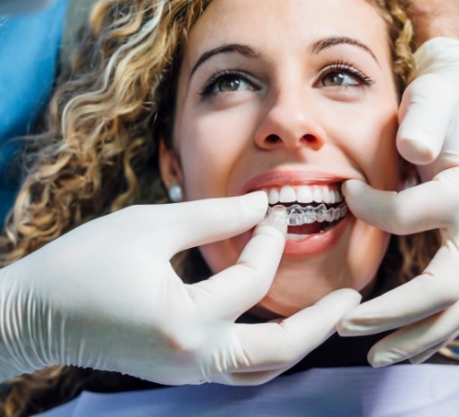 Dentist placing an Invisalign tray