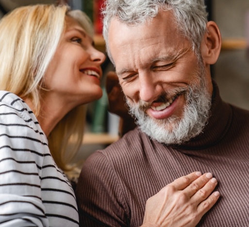 Man and woman talking after Invisalign treatment