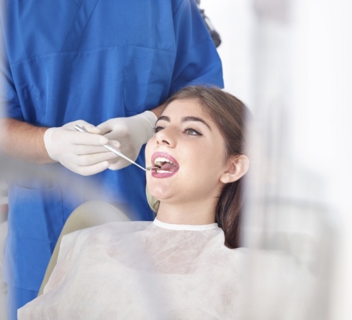 Woman receiving dental checkup and teeth cleaning