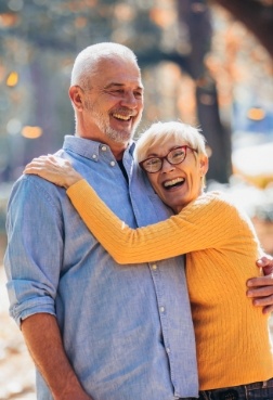 Man and woman with healthy smile after restorative dentistry