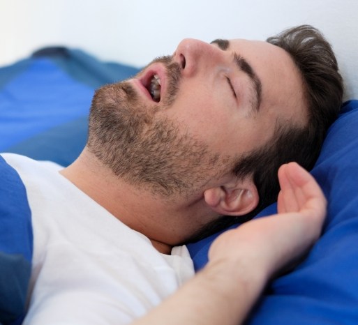 Snoring man in need of sleep apnea treatment