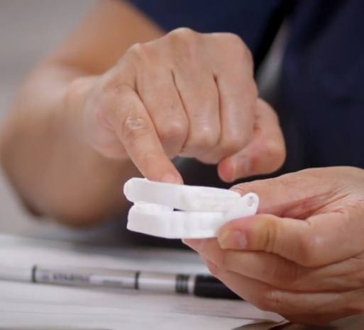 Dental team member holding a sleep apnea treatment device