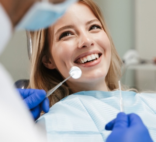 Woman receiving dental checkup to prevent tooth decay