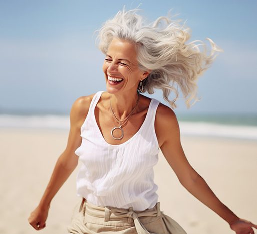 Woman smiling while running on beach